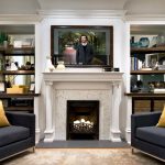 charm living room design with flat screen tv on white mantel fireplace between square twin grey couches with yellow cushions 1