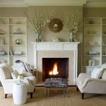 enamor living room design with twin beige couches near craving mantel fireplace and zebra side table with beige barrel decoration