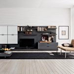 engaging design ideas of modern living room with brown armless wicker sofa and combine with black plush carpet and low coffee table also wooden floor and white wall mounted cabinets also black storage