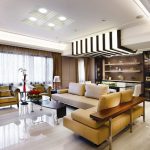 luxurious open plan design interior with elegant decorating and contemporary furniture ideas in living room and dining room with leather brown sectional sofa as well as beautiful floor